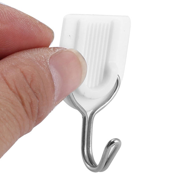 Set of white damage-free hooks for organizing robes and towels.