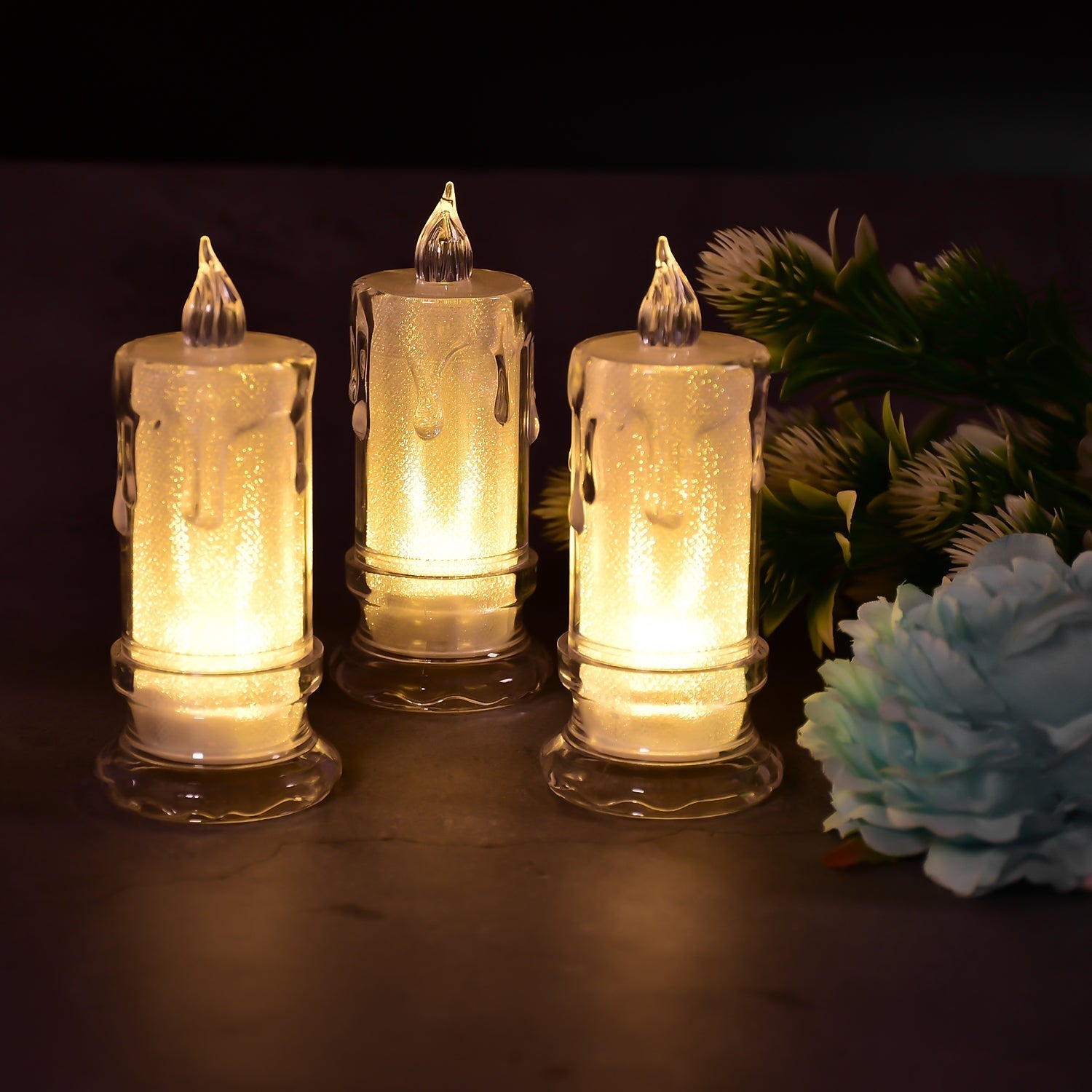 Three Melted Design Flameless Candles glowing softly on a decorative surface, enhancing home ambiance.