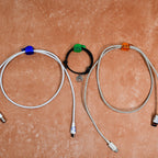 Multiple hand shape wall clips demonstrating their use for organizing small household items.