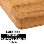 Fresh vegetables being prepared on the spacious wooden cutting board.
