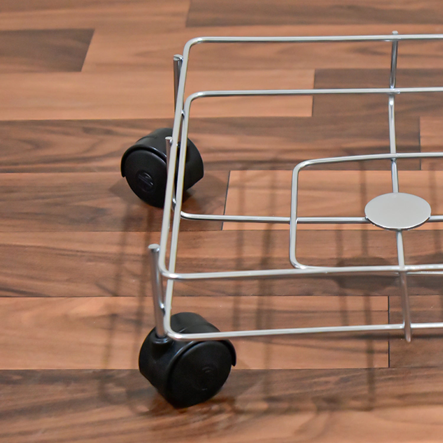 Stainless steel oil stand neatly holding multiple oil bottles and jars on a kitchen counter.