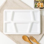 White plastic multi-compartment meal serving tray with 6 sections for portioned dining.