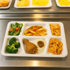 Sectioned plastic meal tray showing spill-guard raised edges for mess-free dining.