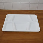 Rectangular sectioned plastic tray with spill-proof raised edges for tidy meal presentation.