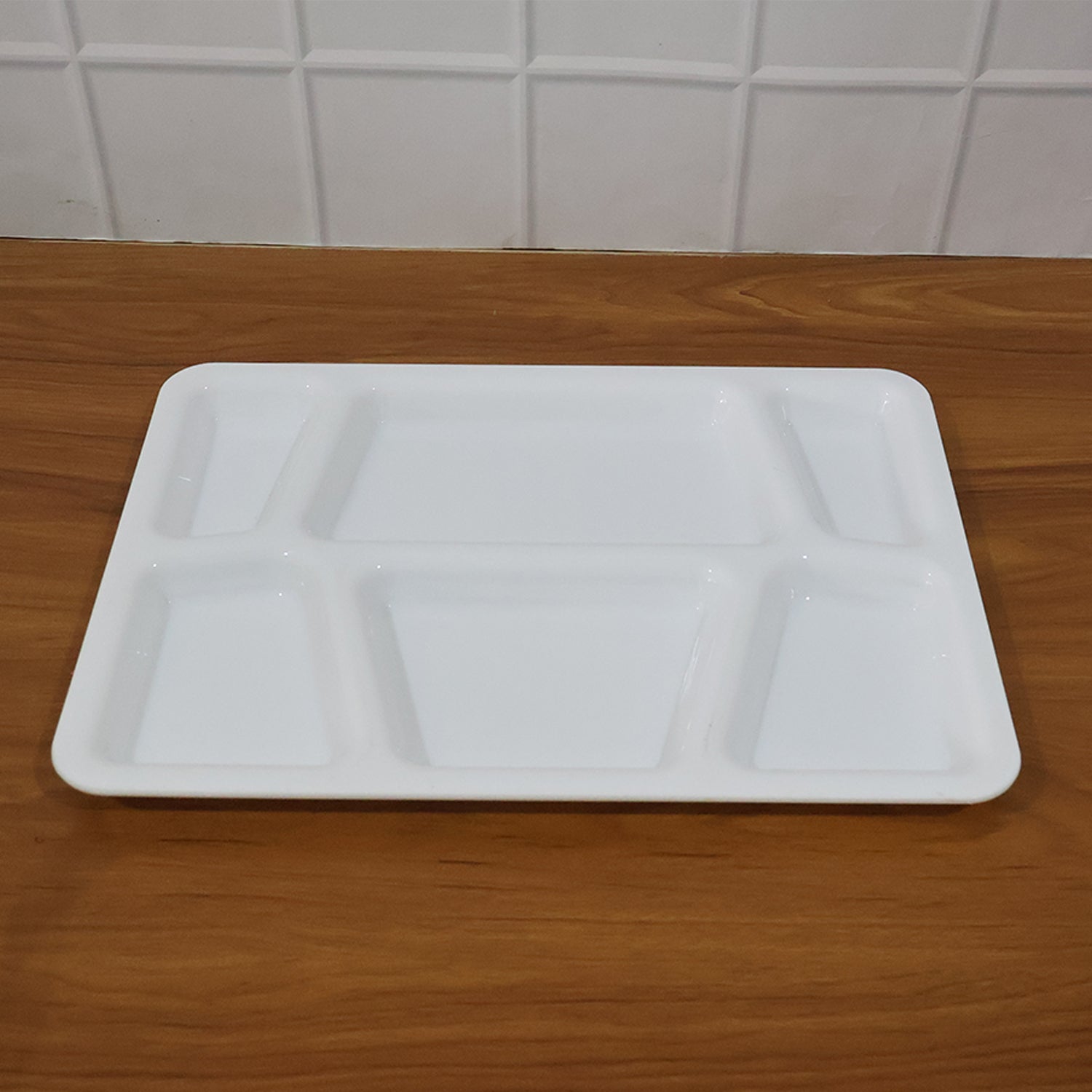 Rectangular sectioned plastic tray with spill-proof raised edges for tidy meal presentation.