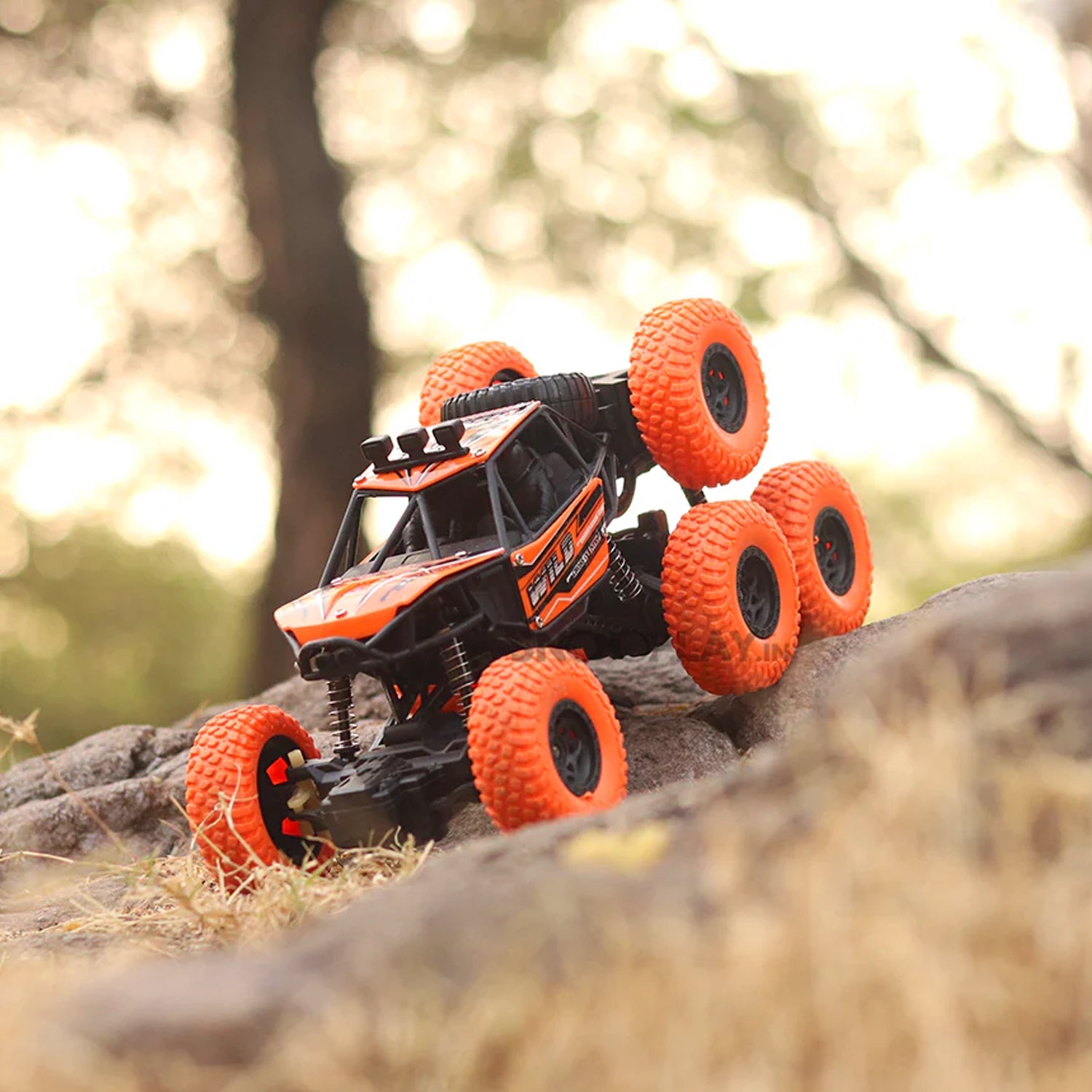 The 8-wheel Rock Climber remote control toy car driving across a rough, uneven surface.