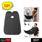 Beard grooming bib securely attached to a mirror with strong suction cups.