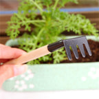Colorful trowel, shovel, and rake from the Kids Garden Tools Set on a natural background.