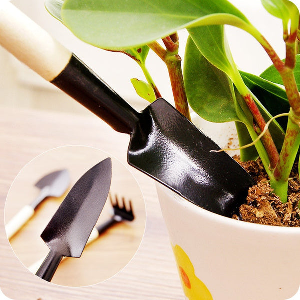 A child happily using the shovel to dig in the garden with their new tools.
