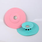 Silicone sink cover protecting drain from food scraps and debris