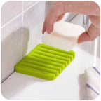 Angled view of the silicone soap holder, ideal for shower or sink.