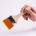 Ergonomic plastic curved handle of a flat paint brush, designed for comfortable, anti-slip grip during use.