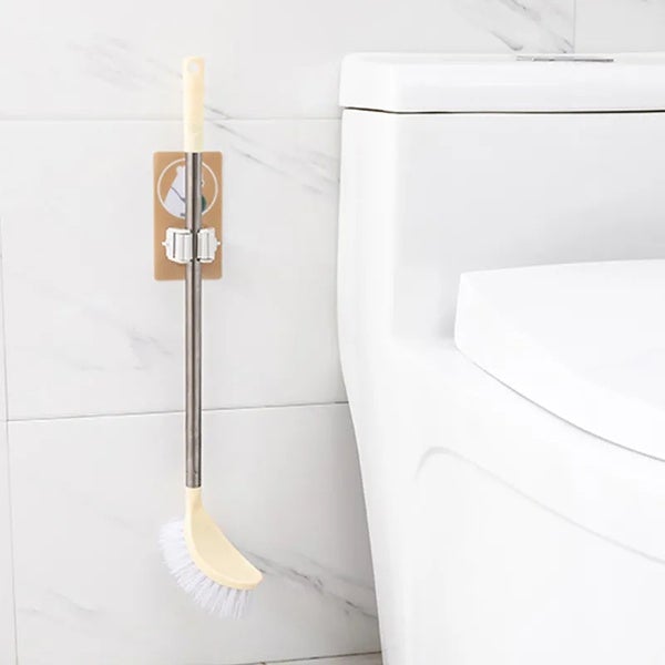 The self-adhesive mop holder demonstrating easy installation on a smooth surface.
