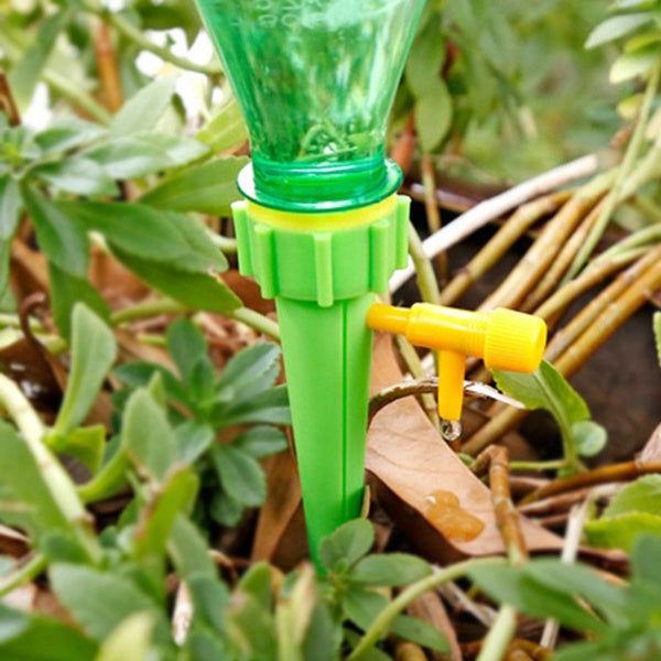 Multiple drip irrigation spikes ensuring consistent watering for a home garden.