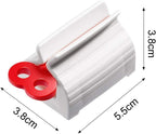 A hand turning the knob of the toothpaste squeezer to effortlessly dispense paste.