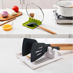 Heat-resistant silicone spatula holder preventing messy spills.