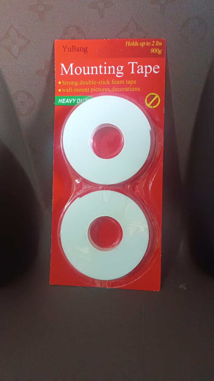 Double sided foam tape strip isolated on white background showing thickness