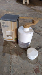 Small ice crusher featuring durable stainless steel blades for homemade shaved ice.