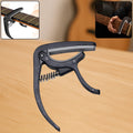 Wagtail Guitar Capo with integrated pick holder on a clean background.