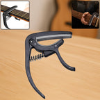 Wagtail Guitar Capo with integrated pick holder on a clean background.