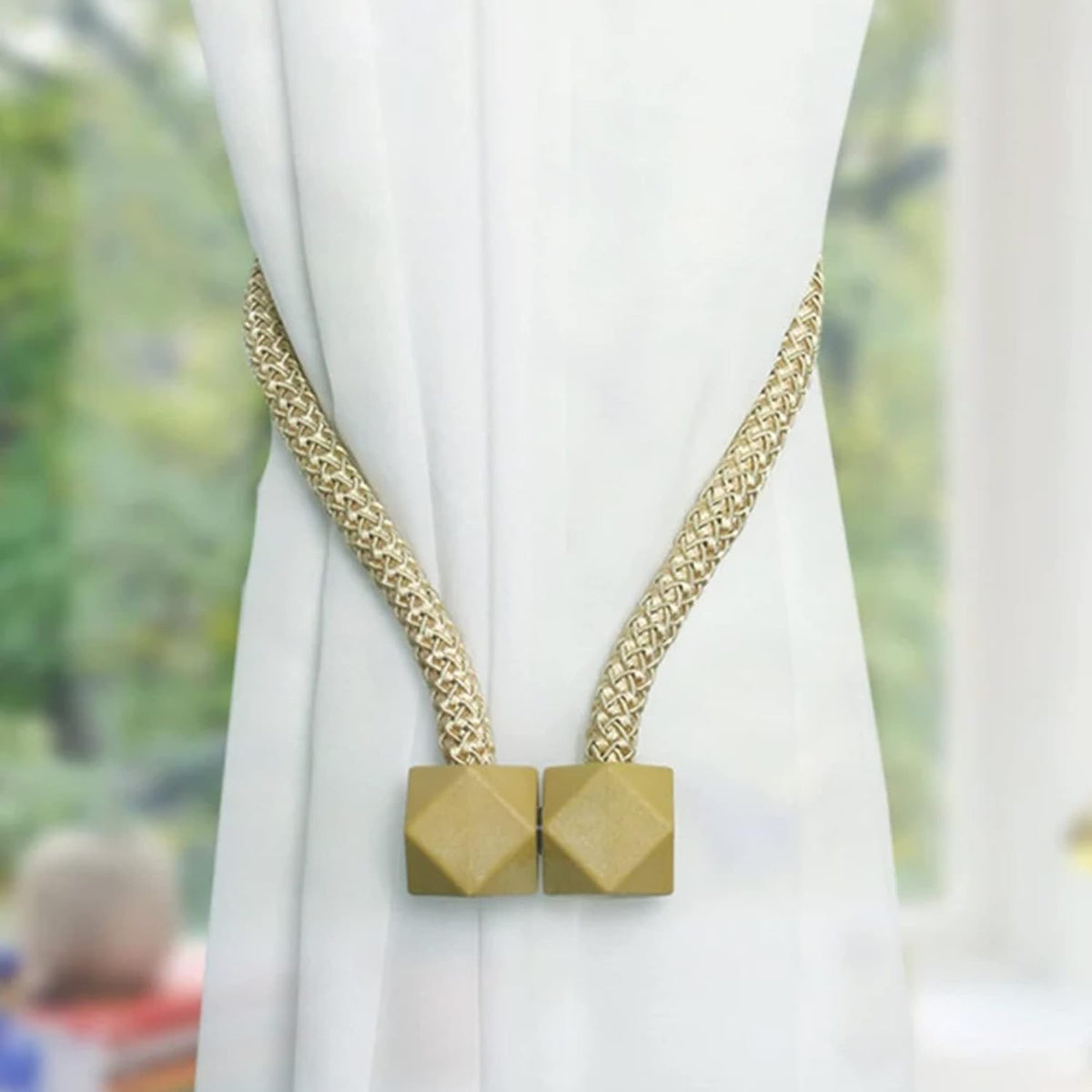 Elegant pearl curtain tiebacks holding back a window curtain, showcasing the non-magnetic design.