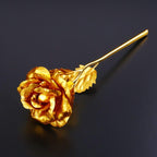 Gold plated rose standing tall inside transparent luxury gift box