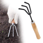 Detailed view of the sharp steel tines on the hand cultivator for effective weeding.