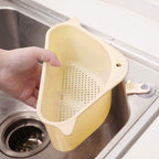 Sink drainer shelf with segmented compartments for kitchen tools.