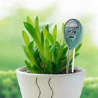Soil tester inserted into a potted plant, showing readings for moisture, pH, and light.