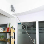 Microfiber duster with 100-inch extendable handle cleaning a high ceiling.
