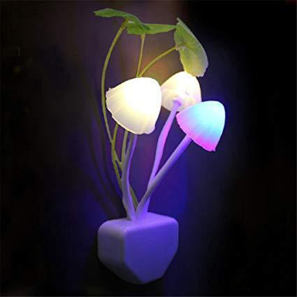 A vibrant LED mushroom night light plugged into a wall socket.