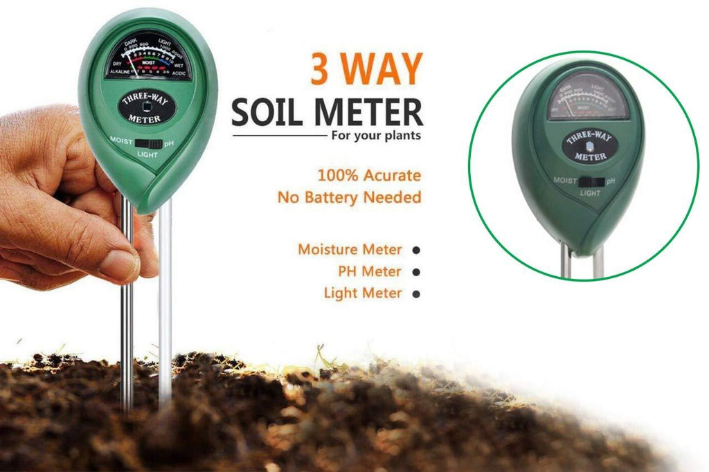 Hand holding the soil moisture tester with pH and light measurement features in a garden.