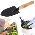 Durable black steel hand digging trowel for garden use.