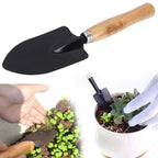 Durable black steel hand digging trowel for garden use.