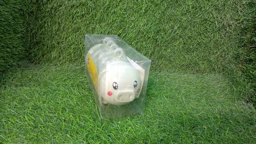 A lifestyle image showing the plastic Pig Shape Ice Mold filled with juice, ready for the freezer.