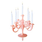 A side view of the elegant birthday candle set, highlighting the reusable stand and individual metallic candles.