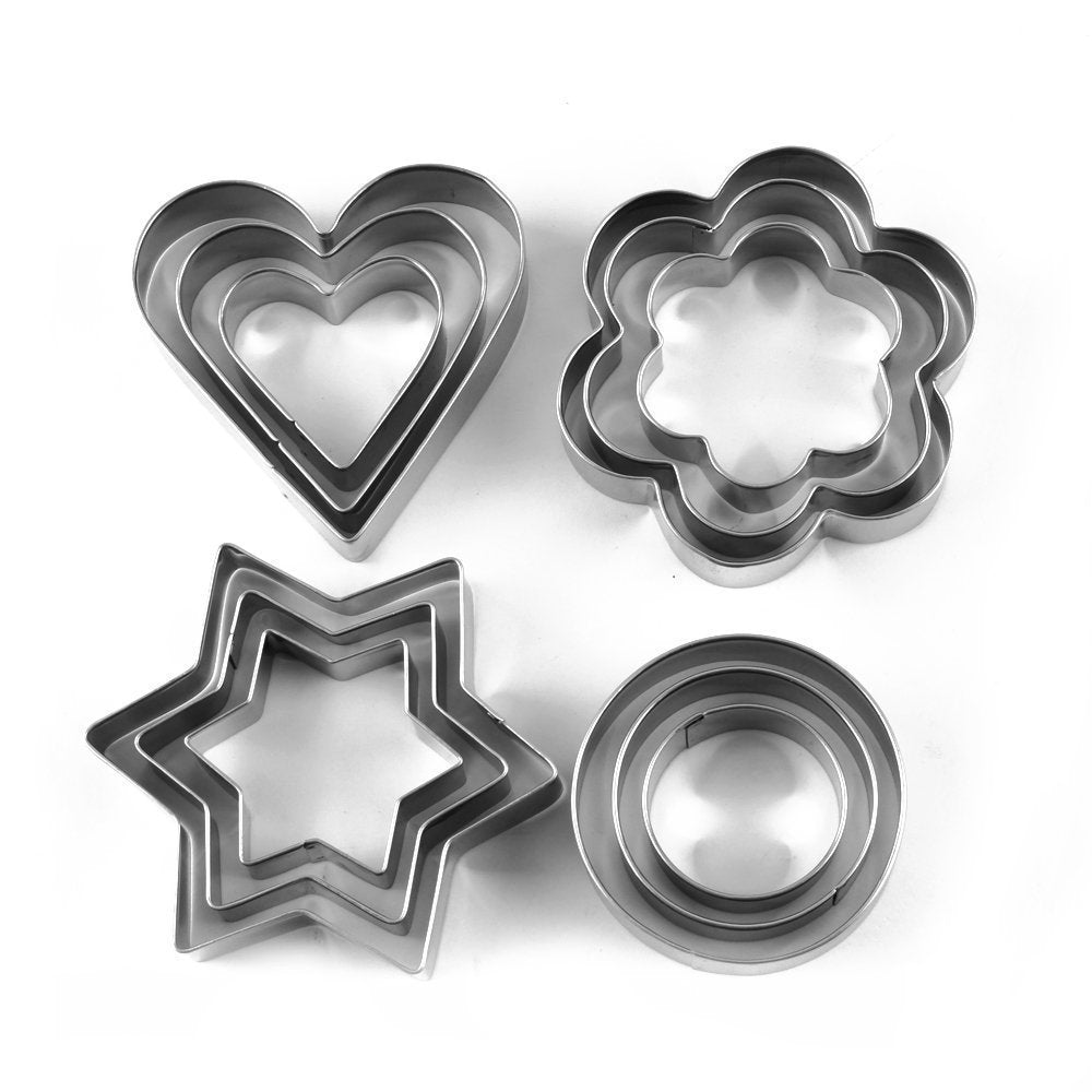 Assorted stainless steel cookie cutters, including heart, star, and flower designs, ready for baking.