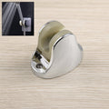 Adjustable hand shower holder with fixing screws in a modern bathroom.