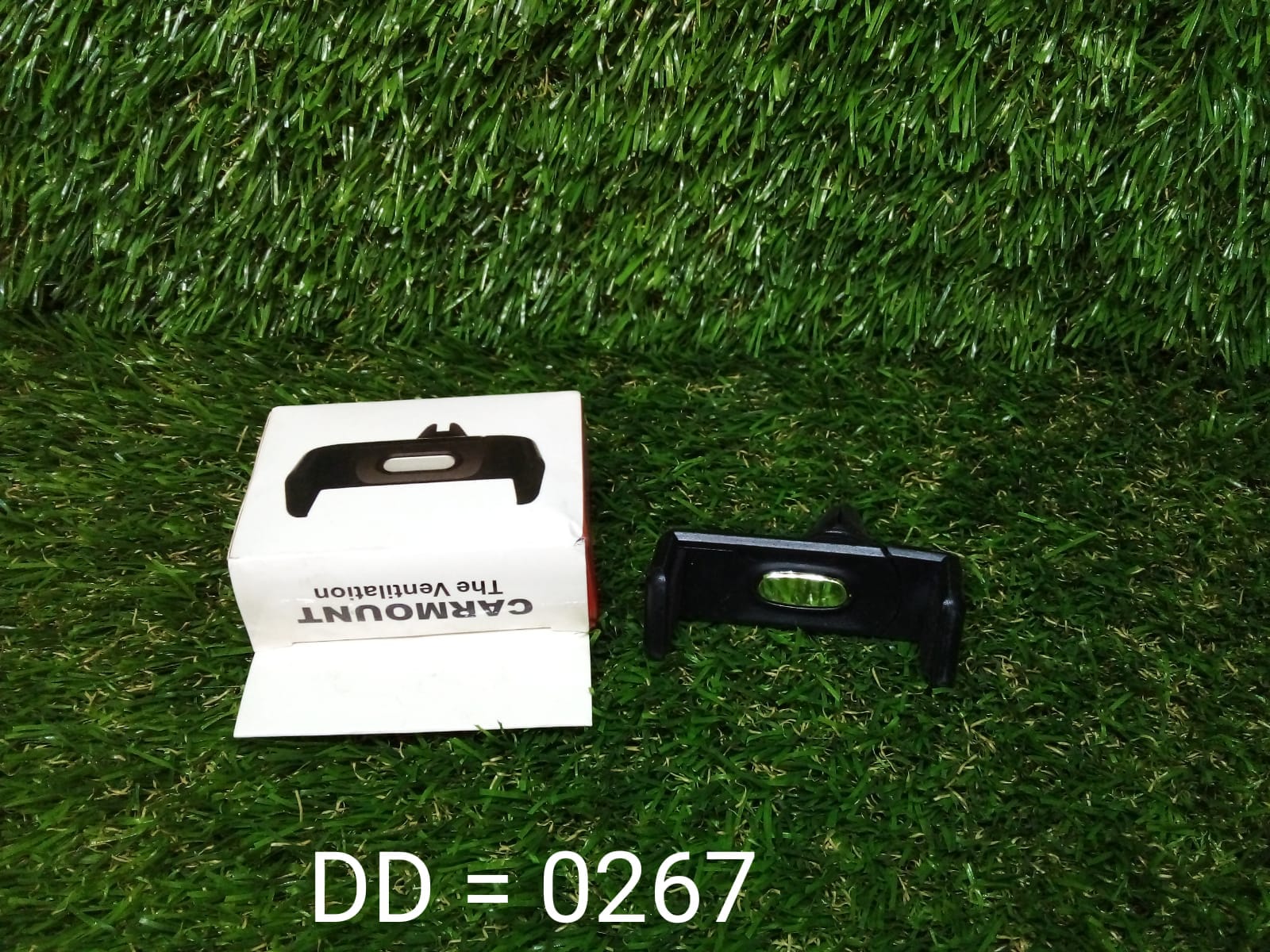 The Car Air Vent Mount used as a mobile stand on a flat surface with a card.