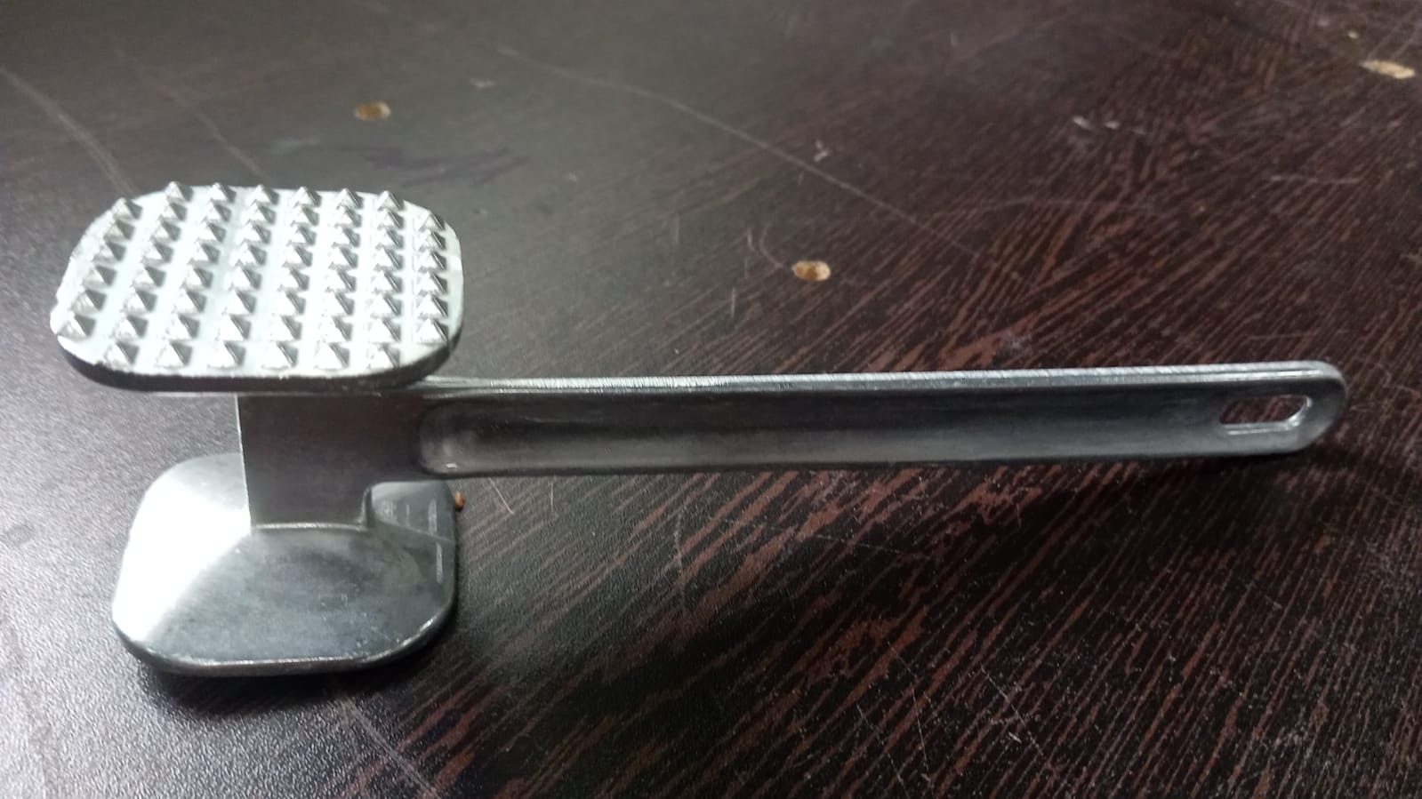 Heavy-duty meat tenderizer hammer, ideal for tenderizing beef steaks.