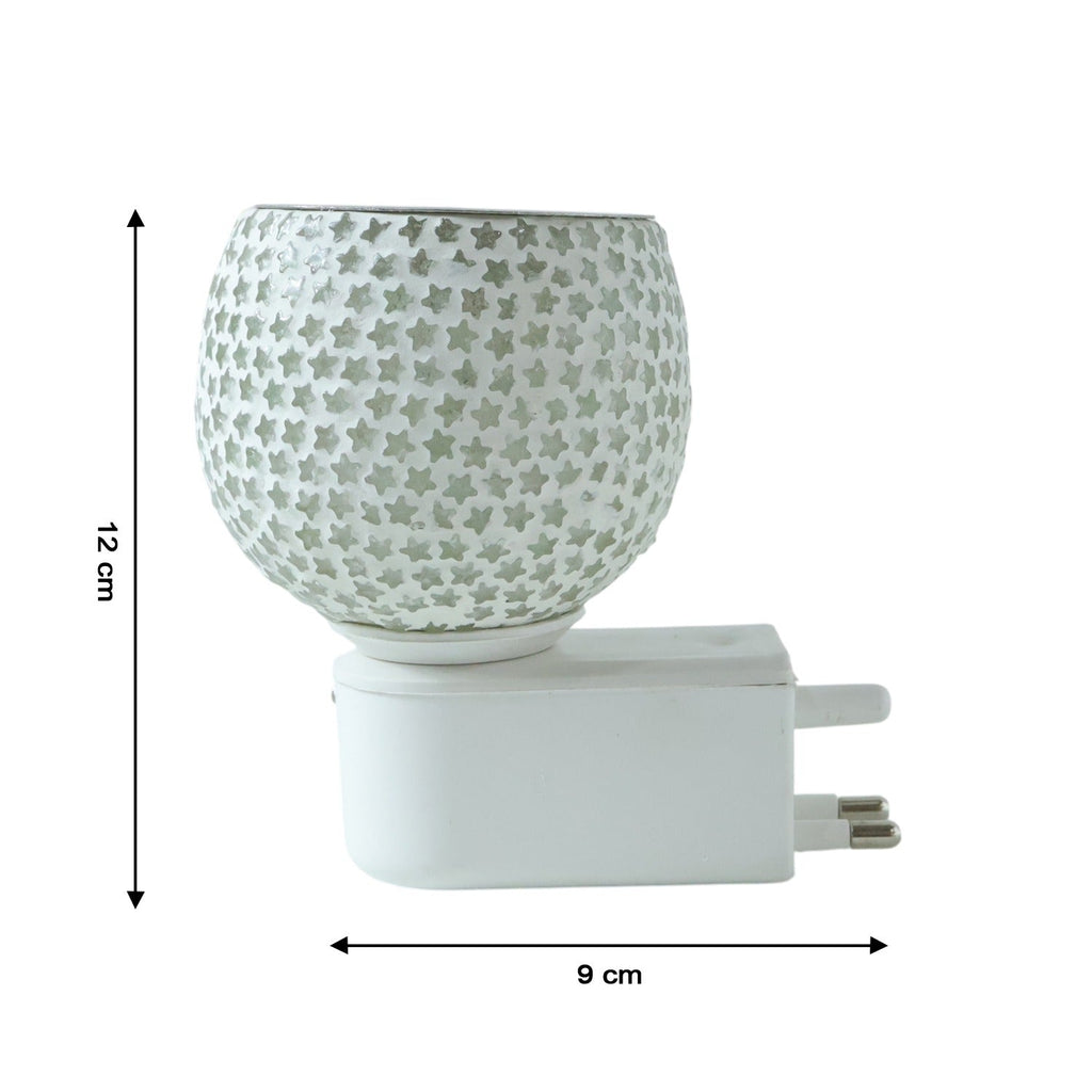 Glass aroma diffuser with star-cut glass design operating in wall outlet
