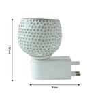 Glass aroma diffuser with star-cut glass design operating in wall outlet