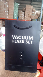 Alternative angle of stainless steel vacuum flask set showing bottle and cups