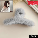 Close-up of a plush hair claw clip, showcasing its soft texture and secure grip.