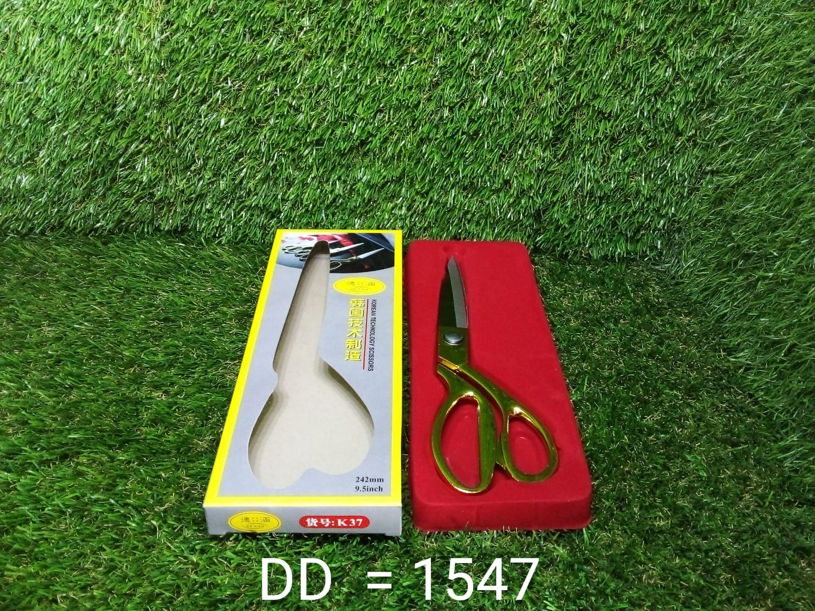 Full view of the golden tailoring scissor, showcasing its design and size.