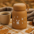 A cute bunny print kids water bottle made of glass, with a blue sipper lid.