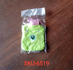 Lifestyle shot of the cute monster hot water bag on a cozy blanket, providing warmth.