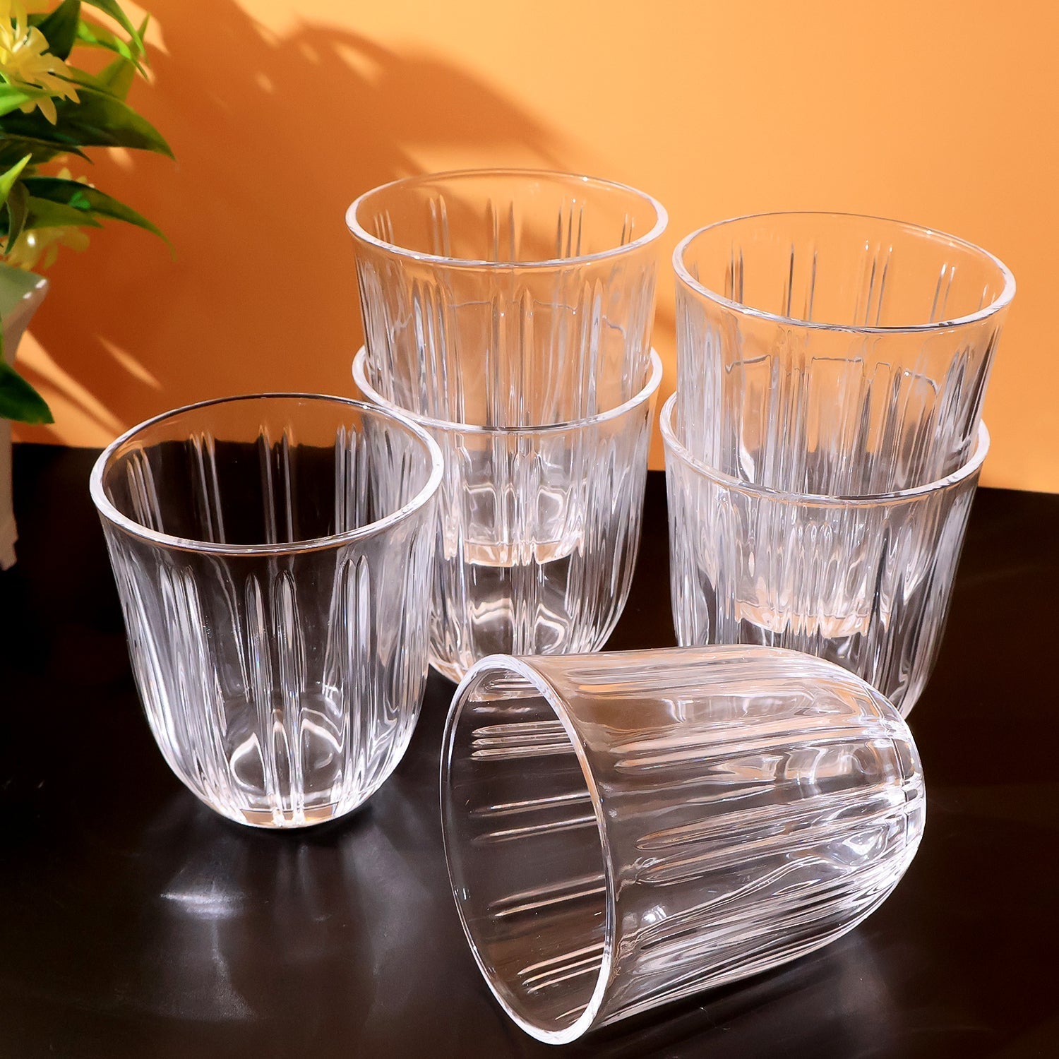 Six clear glass tumblers arranged neatly as premium drinkware set