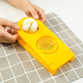 Quickslice 2-in-1 egg slicer creating perfect slices and wedges from a boiled egg.