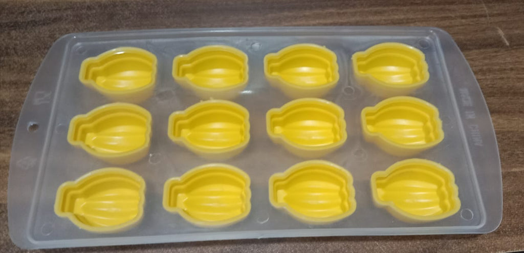 Glass of chilled beverage with delightful fruit-shaped ice cubes and the silicone mold.